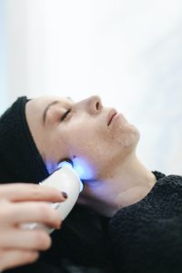 Woman laying down and receiving a facial treatment